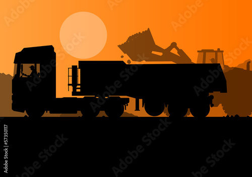 Excavator loader and heavy truck trailer at construction site wi
