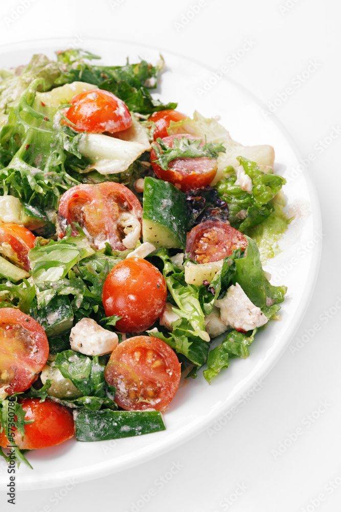 Fresh vegetable salad with tomato, cucumber, feta and greens Fresh vegetable salad with tomato, cucumber, feta and greens