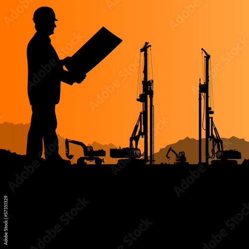 Engineers with excavator loaders and tractors digging at industr