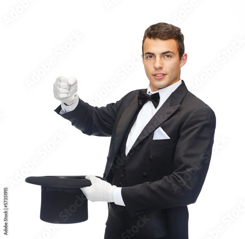 magician in top hat showing trick photo