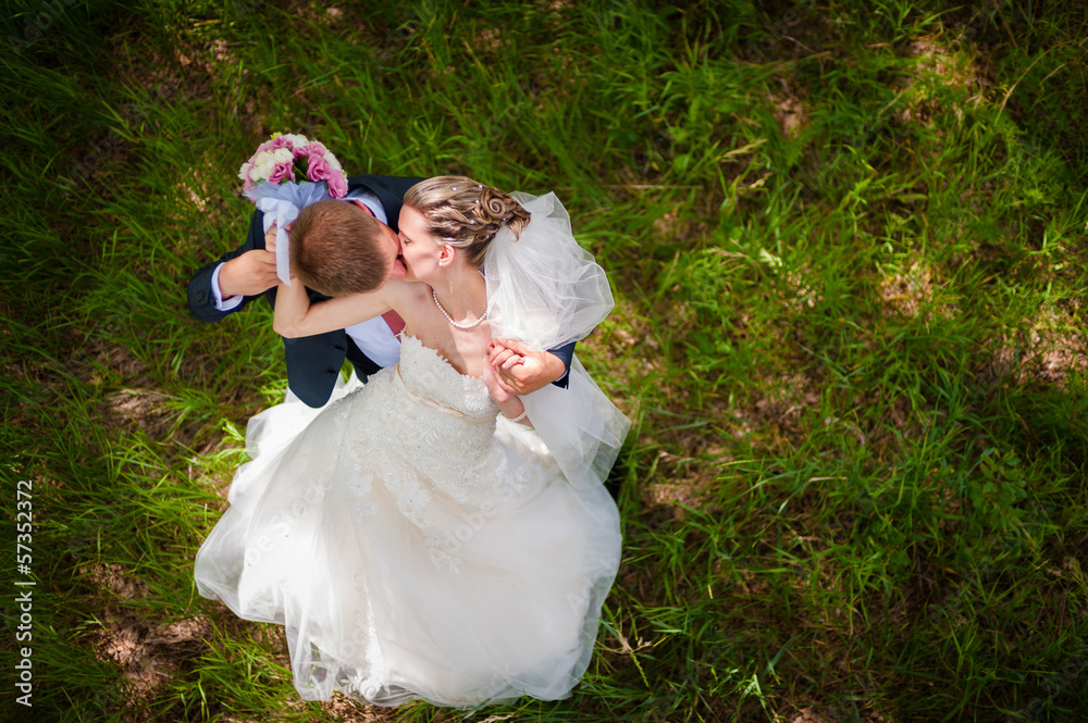 Groom and bride on green glade Groom and bride on green glade