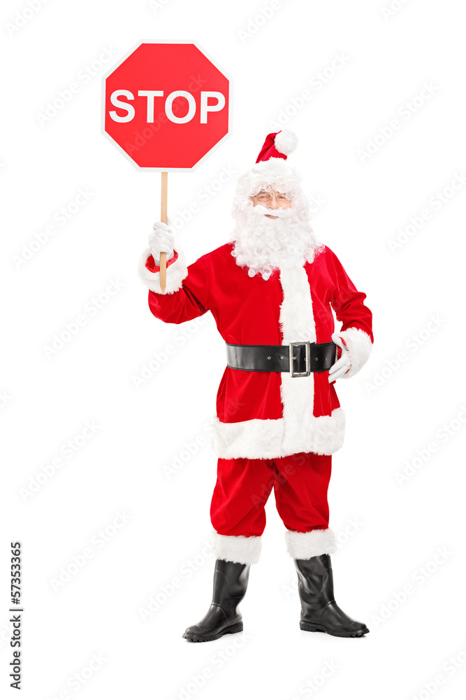 Full length portrait of a smiling Santa Claus holding stop sign Full length portrait of a smiling Santa Claus holding stop sign