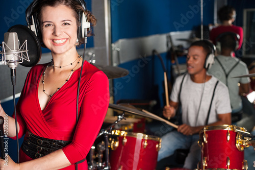 Female singer recording a track in studio © stockyimages