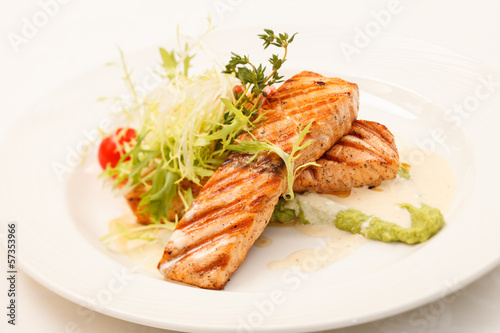 Grilled salmon steak with salad