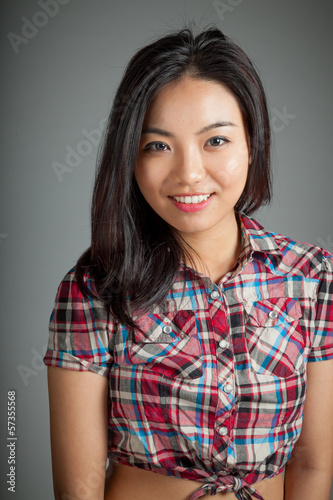 Portrait of sexy asian cowgirl smiling