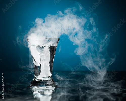 Photo shot glass of vodka with ice vapor