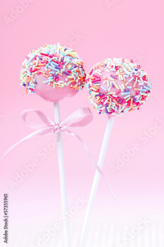 Canvas Print Pink cake pops decorated with colorful sprinkles.