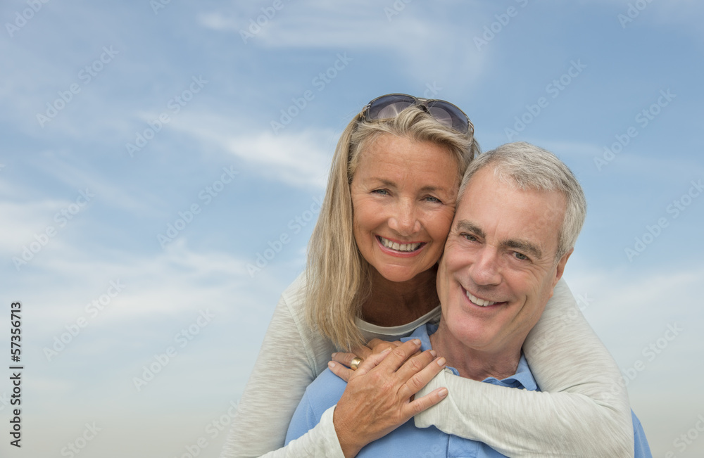 Senior Man Piggybacking Woman Against Sky Senior Man Piggybacking Woman Against Sky
