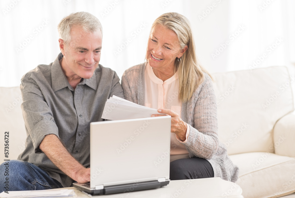 Couple Paying Bills Through Laptop At Home