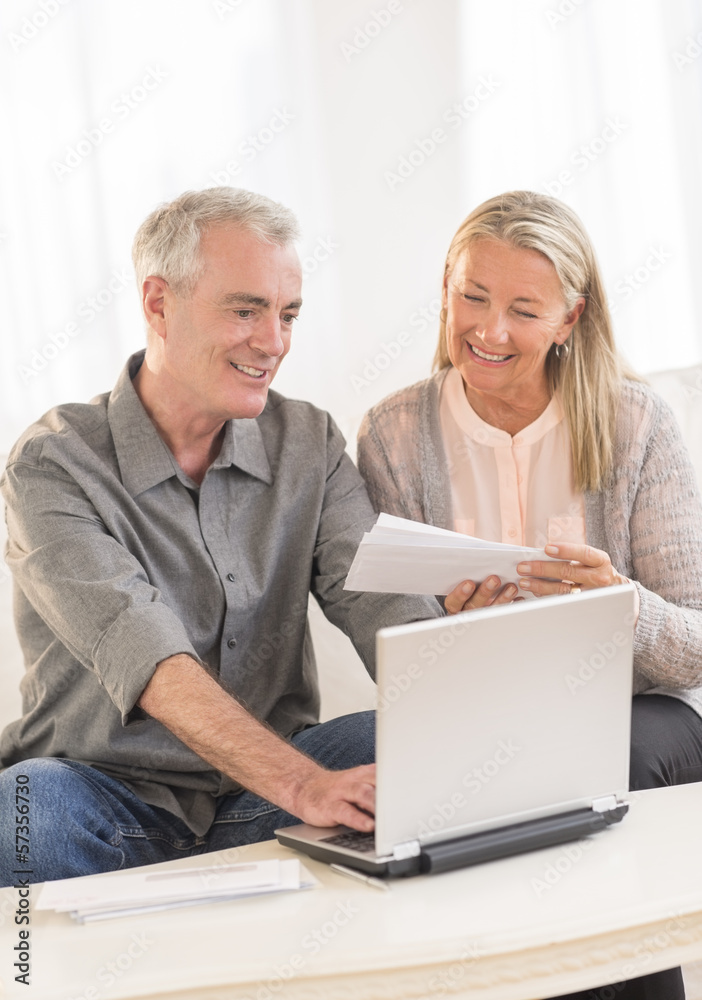 Couple With Laptop Calculating Bills At Home Couple With Laptop Calculating Bills At Home