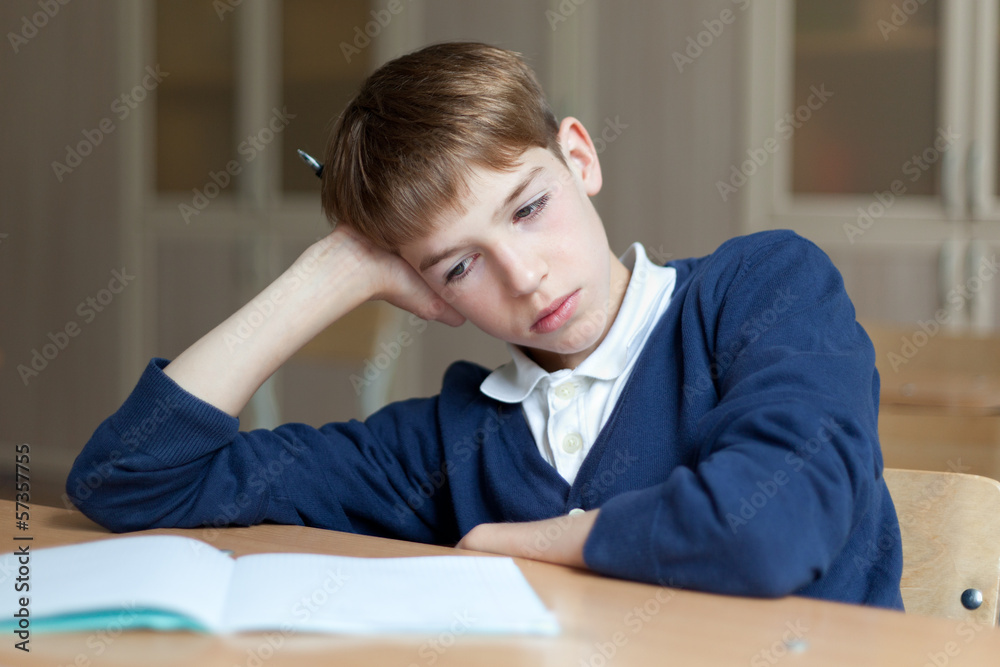 Diligent preschool sitting at desk, classroom Diligent preschool sitting at desk, classroom