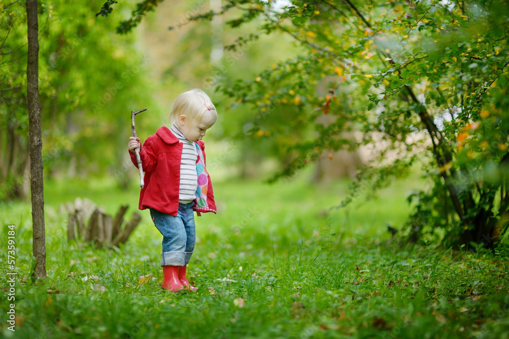 Adorable girl hiking in the forest on autumn day Adorable girl hiking in the forest on autumn day