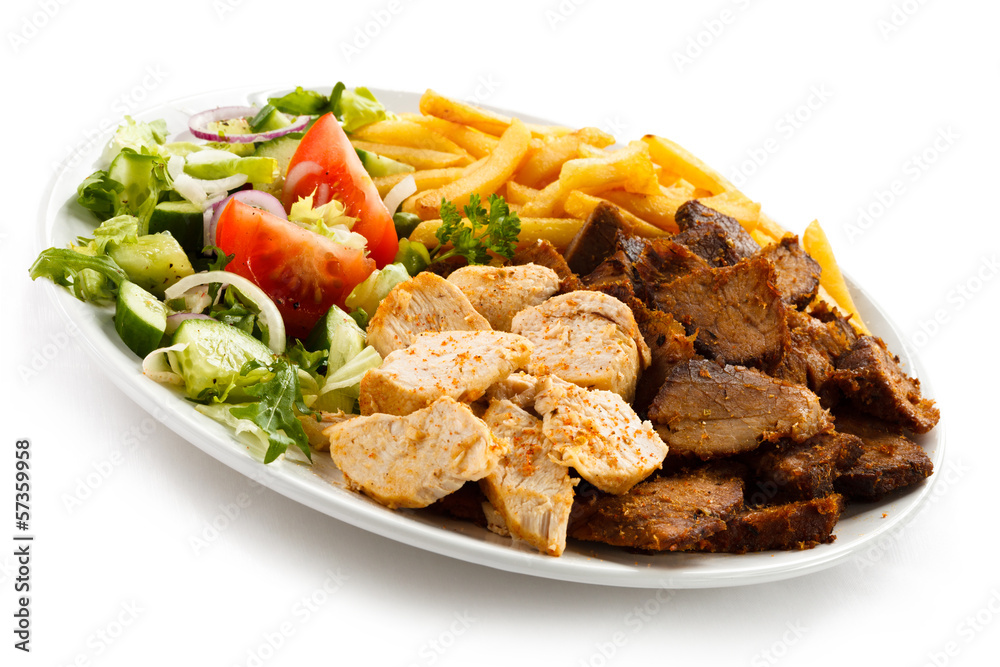 Grilled meat with French fries and vegetables Grilled meat with French fries and vegetables