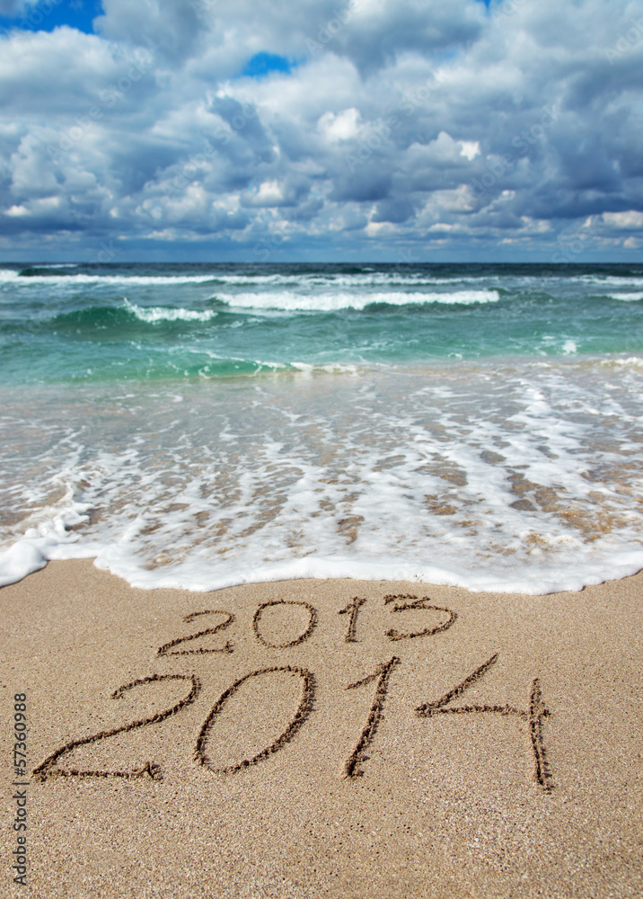Happy New Year 2014 wash away 2013 concept on sea beach Happy New Year 2014 wash away 2013 concept on sea beach