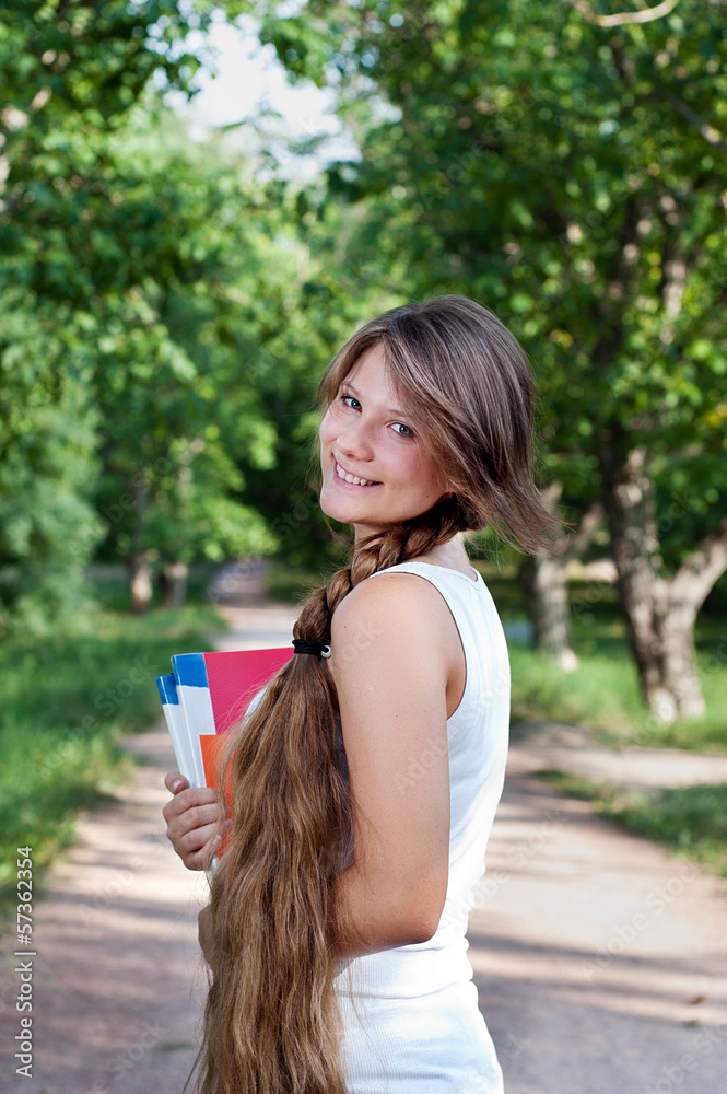 Beautiful teenage girl with long braid in the park Beautiful teenage girl with long braid in the park