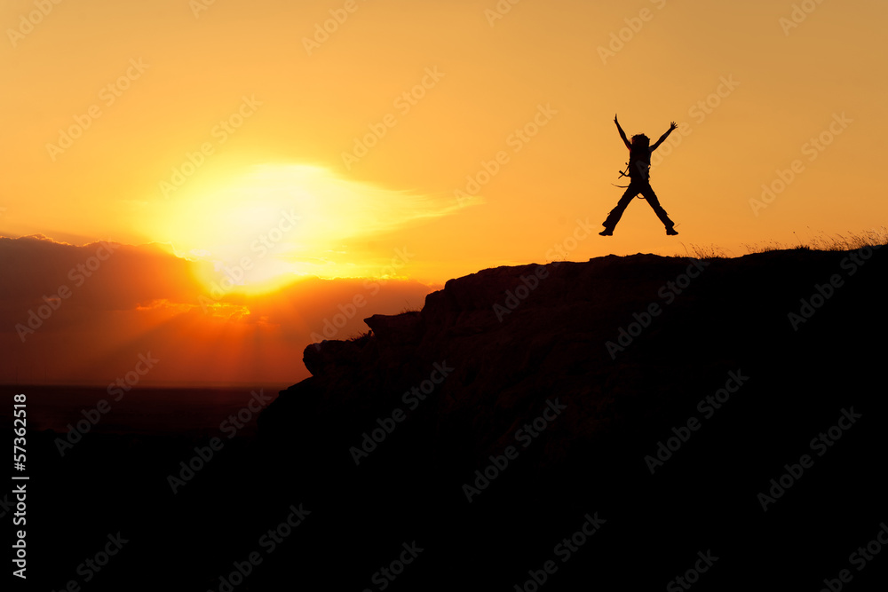 Silhouette of jumping woman with backpack