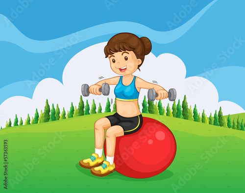 A girl exercising with a barbell and a bouncing ball