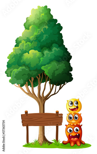 Three monsters playing near the wooden signboard under the tree