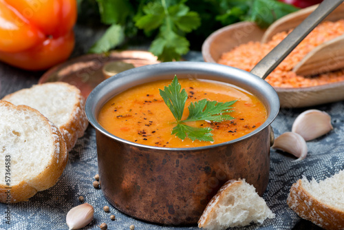 red lentil soup with pepper and spices in saucepan