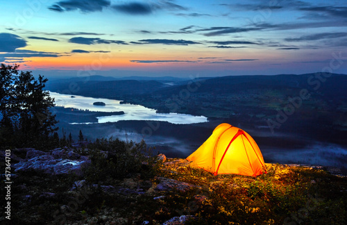 .A tent lit up at dusk
