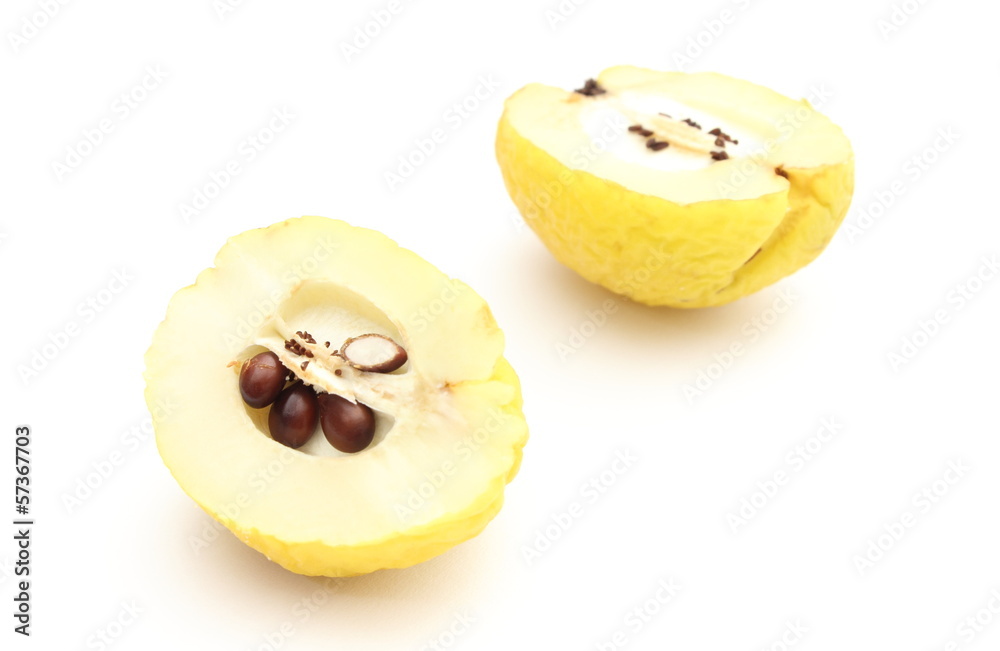 Two halves of yellow quince on a white background