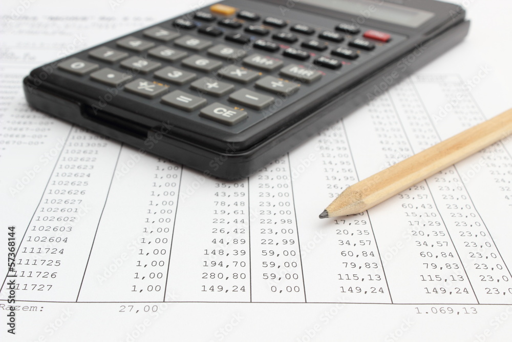 Calculator and pencil lying on spreadsheet Calculator and pencil lying on spreadsheet