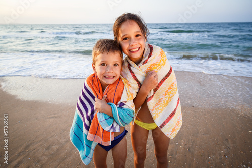 Two smiling kids on the beach