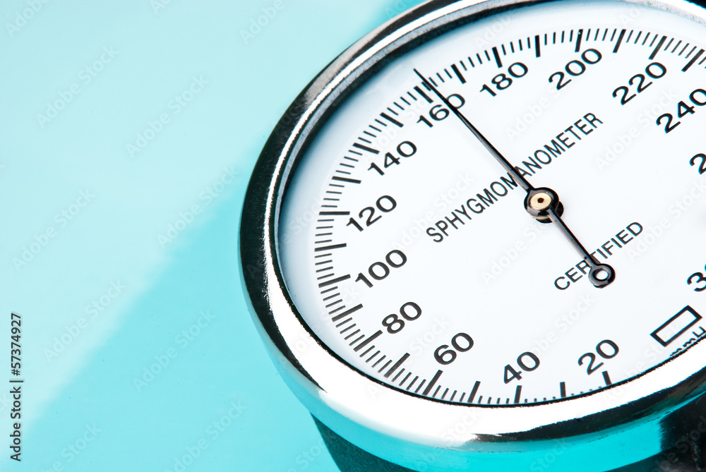 Sphygmomanometer on blue, reflective background Sphygmomanometer on blue, reflective background