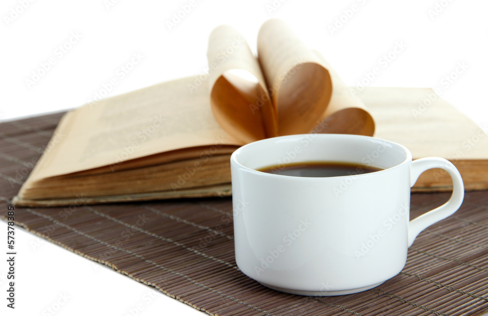 Cup of coffee and book on bamboo mat on white background Cup of coffee and book on bamboo mat on white background