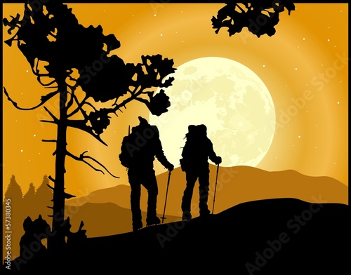 Two climbers in silhouette climbing the mountain