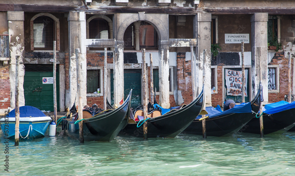 Black and Blue Gondolas Parked by Old Building