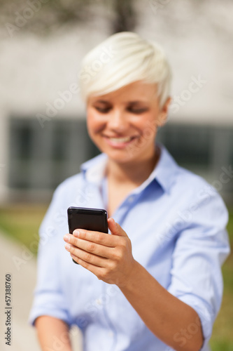 Portrait of blonde businesswoman with mobile phone