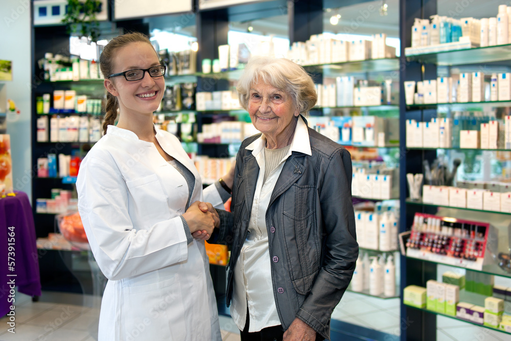 Pharmacist assisting an elderly lady. Pharmacist assisting an elderly lady.