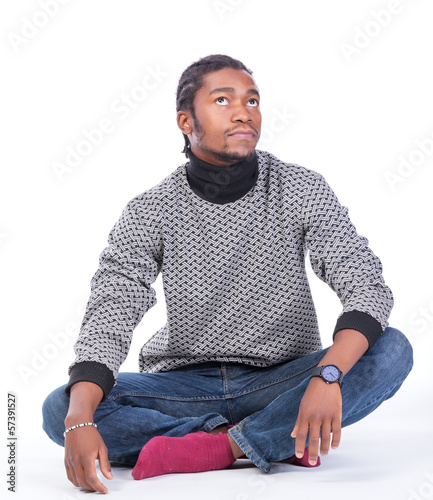 Young African-American male sitting on the ground