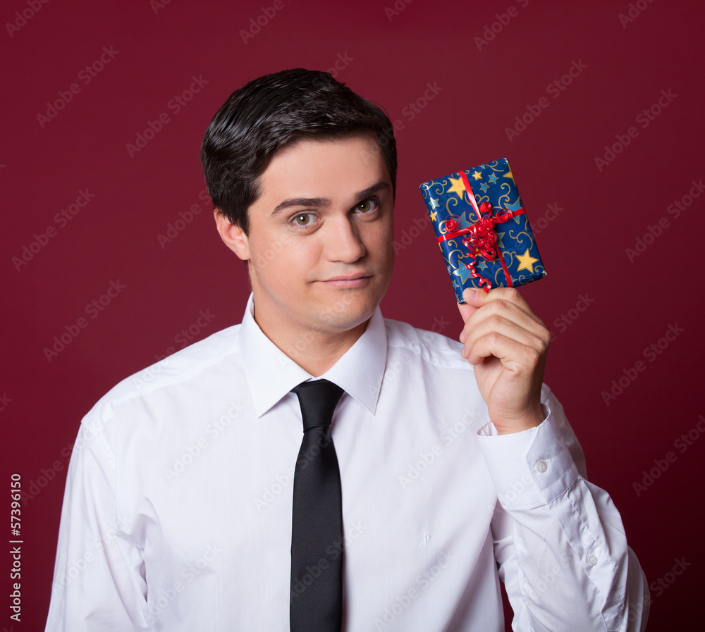 Handsome man with gift. Studio shot. Handsome man with gift. Studio shot.