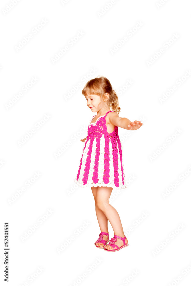 Happy little girl in knitted pink dress dancing. Happy little girl in knitted pink dress dancing.