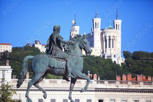 Famous statue of Louis XIV and Basilique of Notre Dame de Fourvi