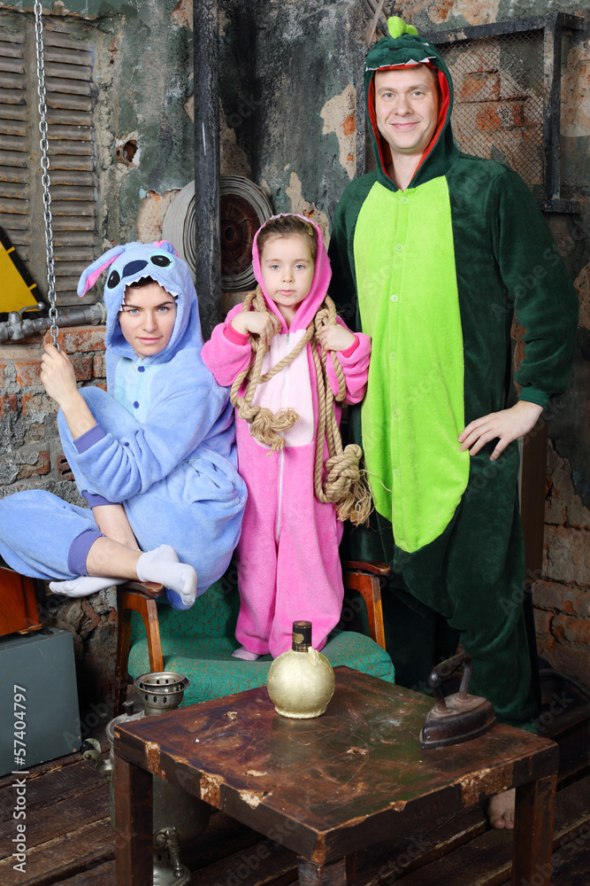 Father, mother and little daughter in costumes of dragones