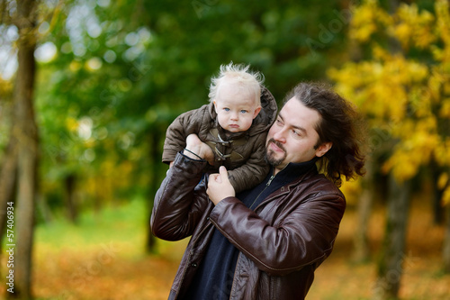 Young father and his toddler daughter at fall