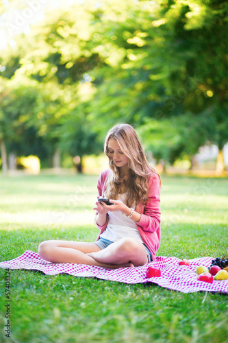 Girl using her mobile phone outdoors © Ekaterina Pokrovsky