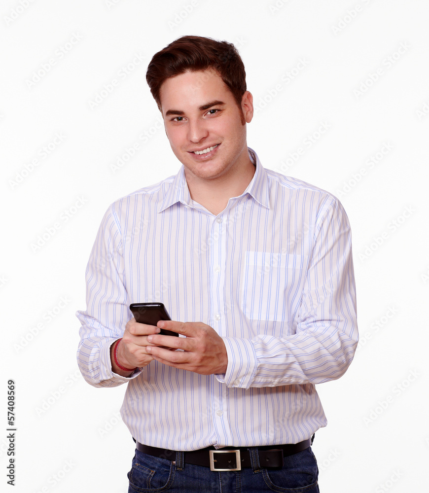 Cute young man smiling and texting Cute young man smiling and texting