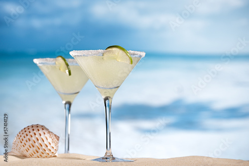 margarita  cocktail on beach, blue sea and sky background