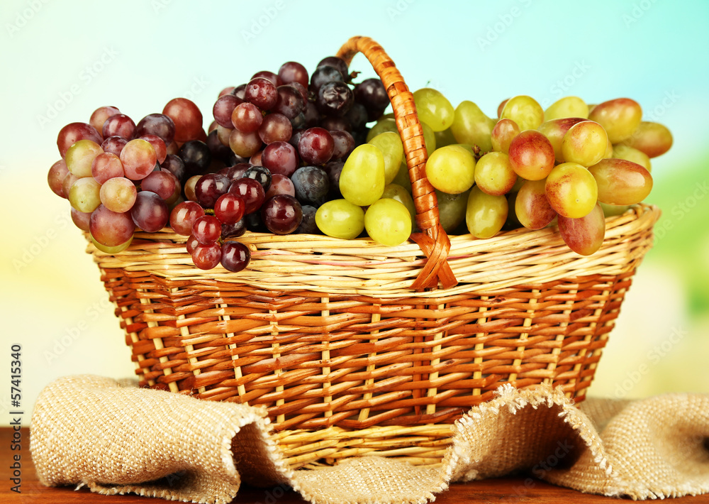 Fresh grape on wicker mat on bright background Fresh grape on wicker mat on bright background