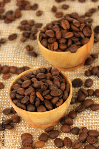 Coffee beans in bowls on table close-up