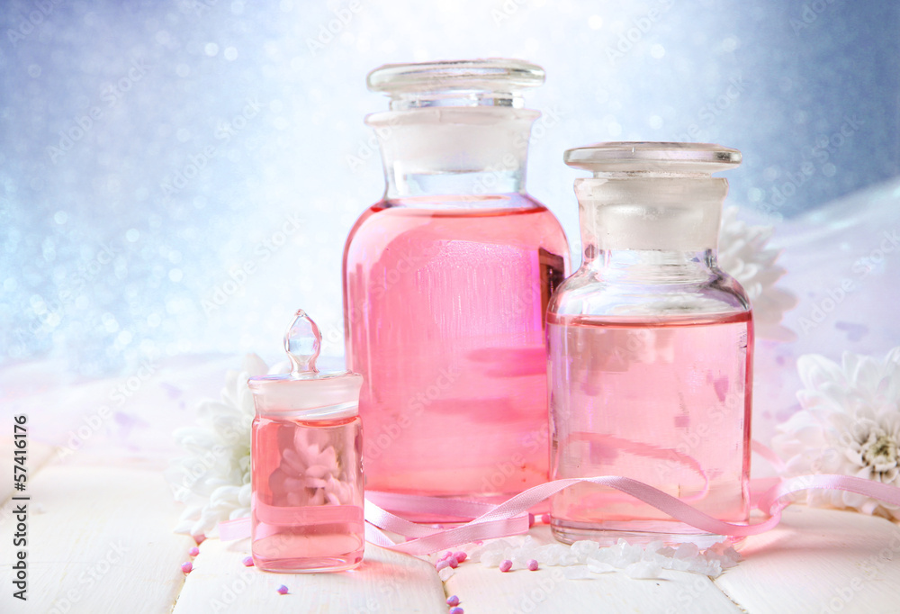 Glass bottles with color essence, on blue background Glass bottles with color essence, on blue background