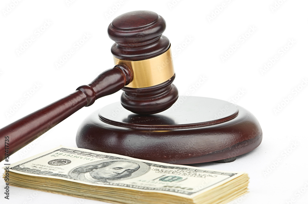 Law gavel on a stack of American money. Law gavel on a stack of American money.