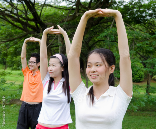 Young asian adults exercise in the park