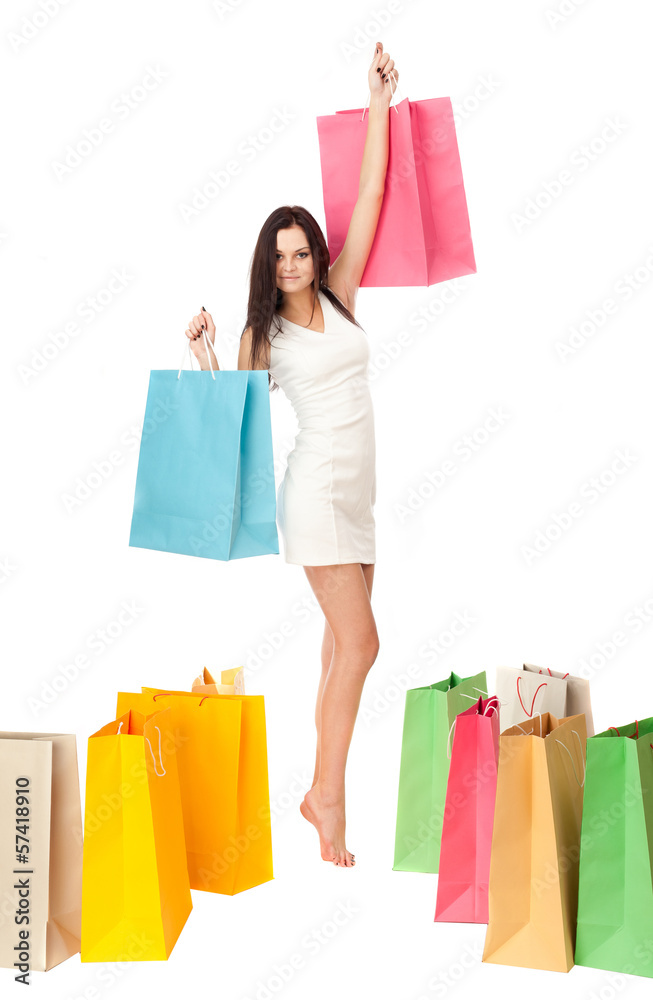 Beautiful brunette with a shopping bag on a white background.