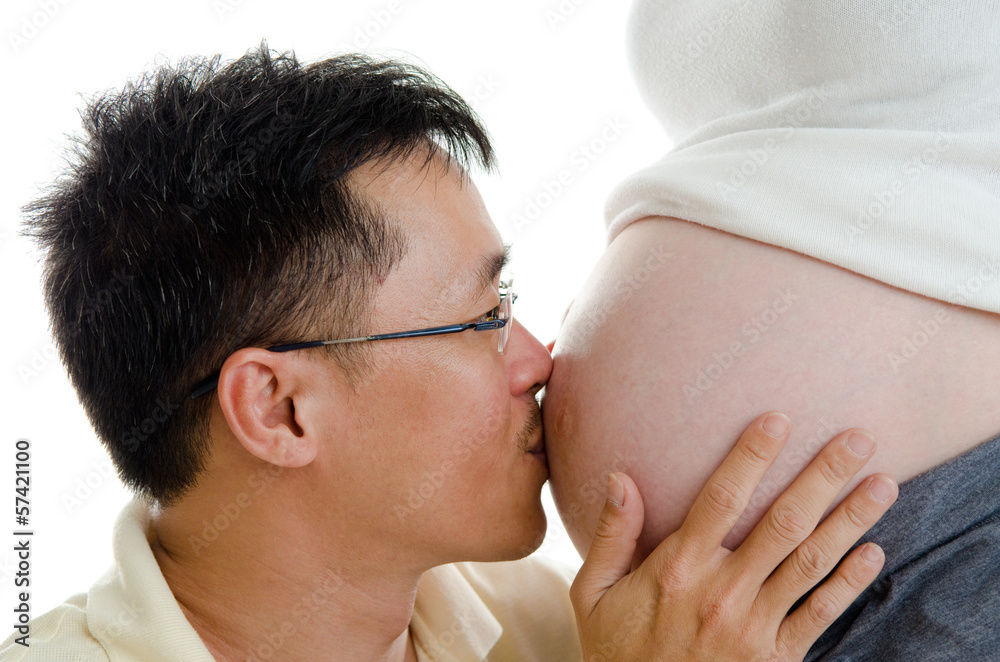 Asian man kiss his pregnant wife's stomach Asian man kiss his pregnant wife's stomach