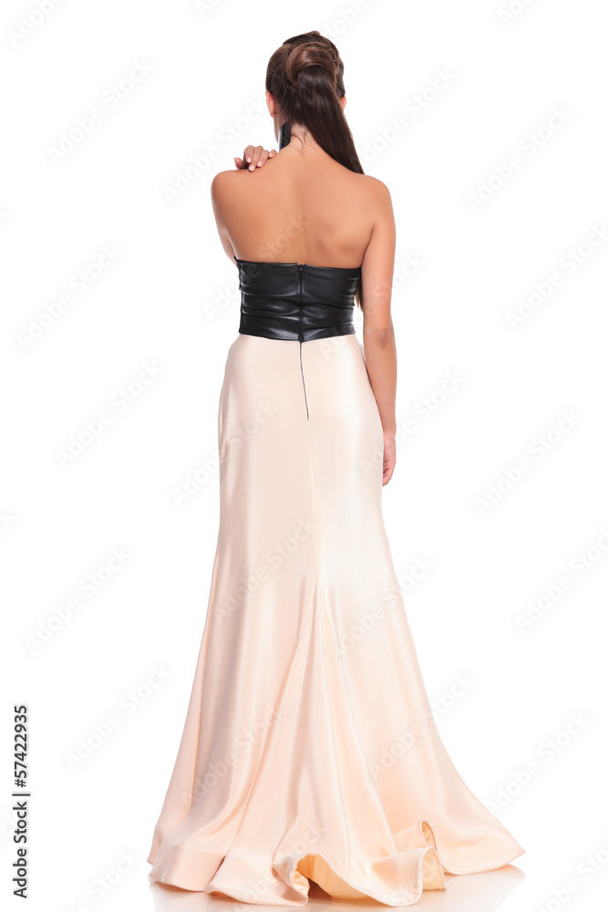 picture from behind of a young woman in beautiful gown picture from behind of a young woman in beautiful gown